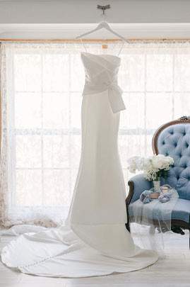 the wedding dress hanging in a room